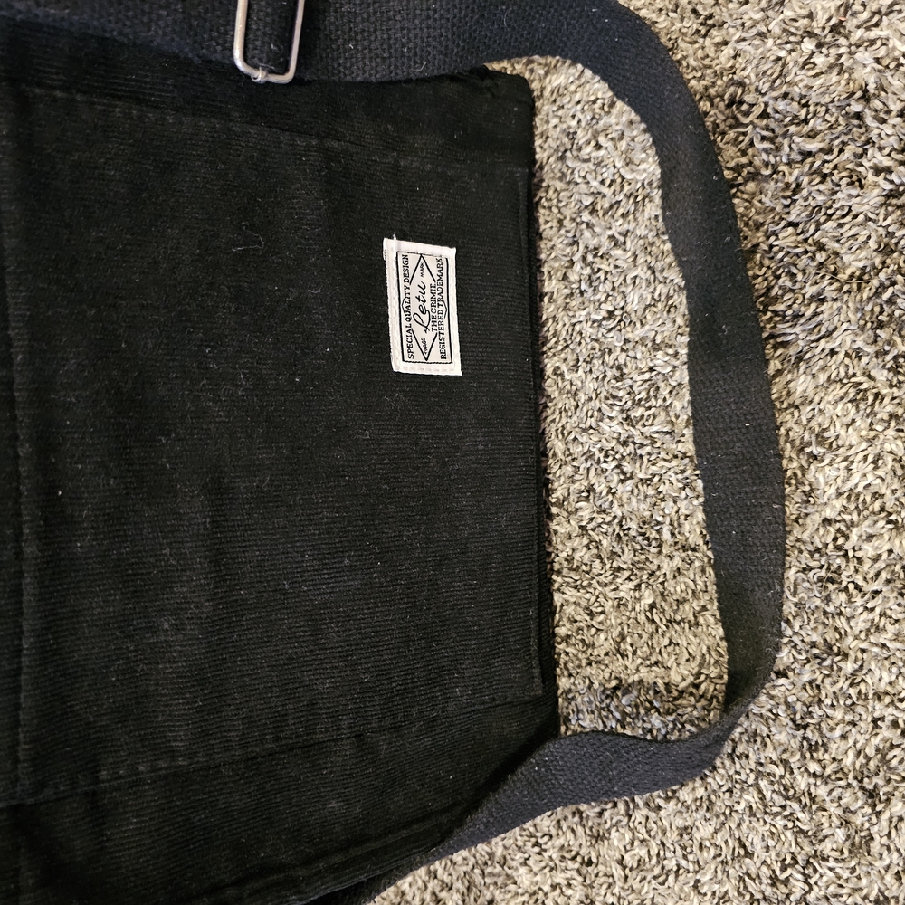 Black Messenger Bag with Comfortable Strap and Textured Fabric